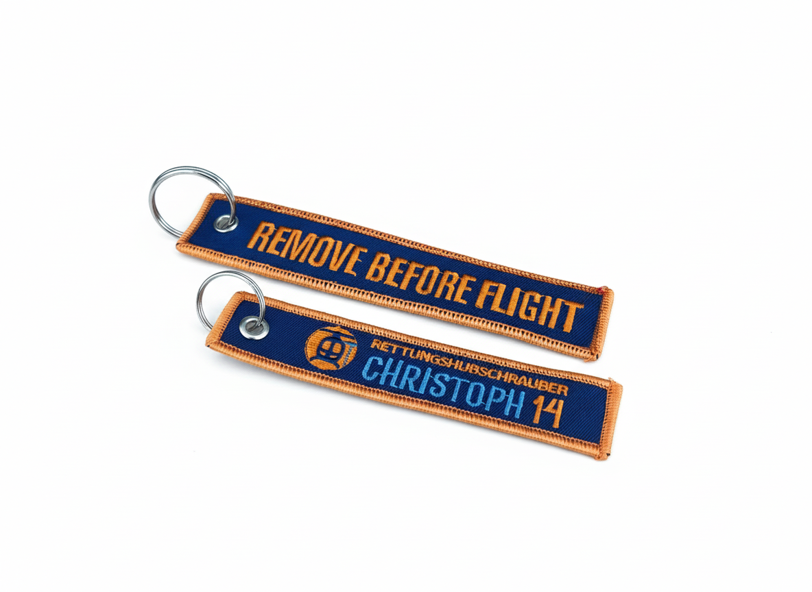 Schlüsselanhänger Christoph 14 orange, Vorder- und Rückseite freigestellt vor weißem Hintergrund