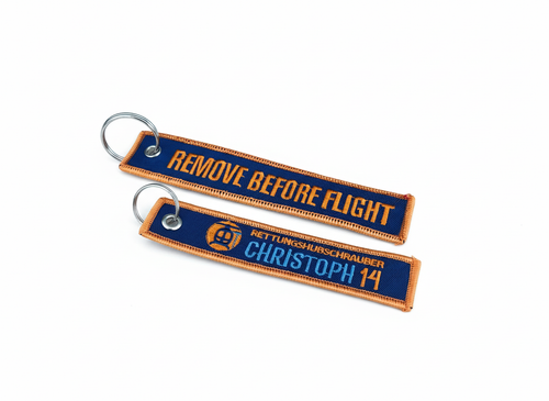 Schlüsselanhänger Christoph 14 orange, Vorder- und Rückseite freigestellt vor weißem Hintergrund